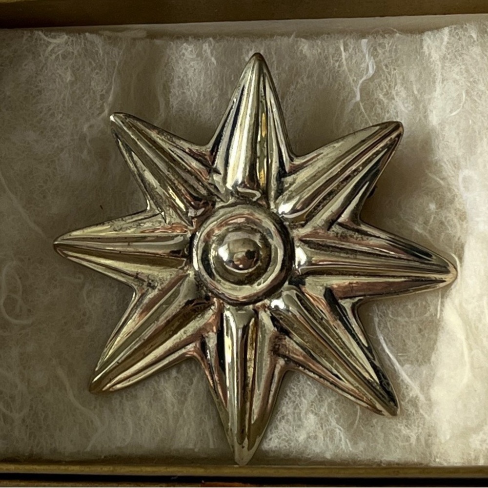 Elegant Silver Starburst Brooch